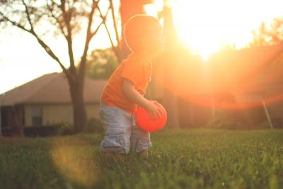 Boy playing with a red ball