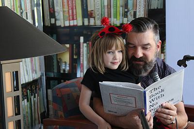 Picture from 2017 Readathon feature a dad and daughter reading together