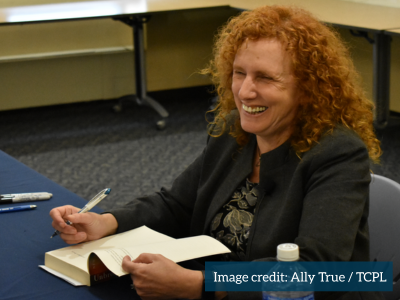 Maia Szalavitz smiles as she signs books at TCPL on April 19, 2025