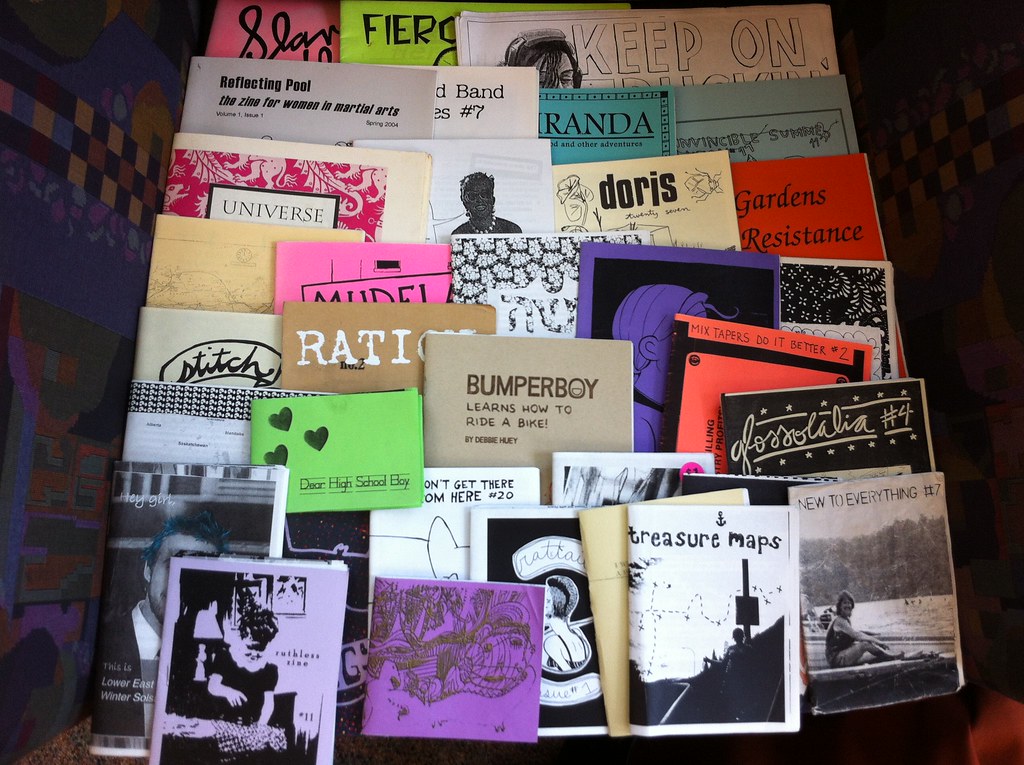 An assortment of handmade zines in a pile.