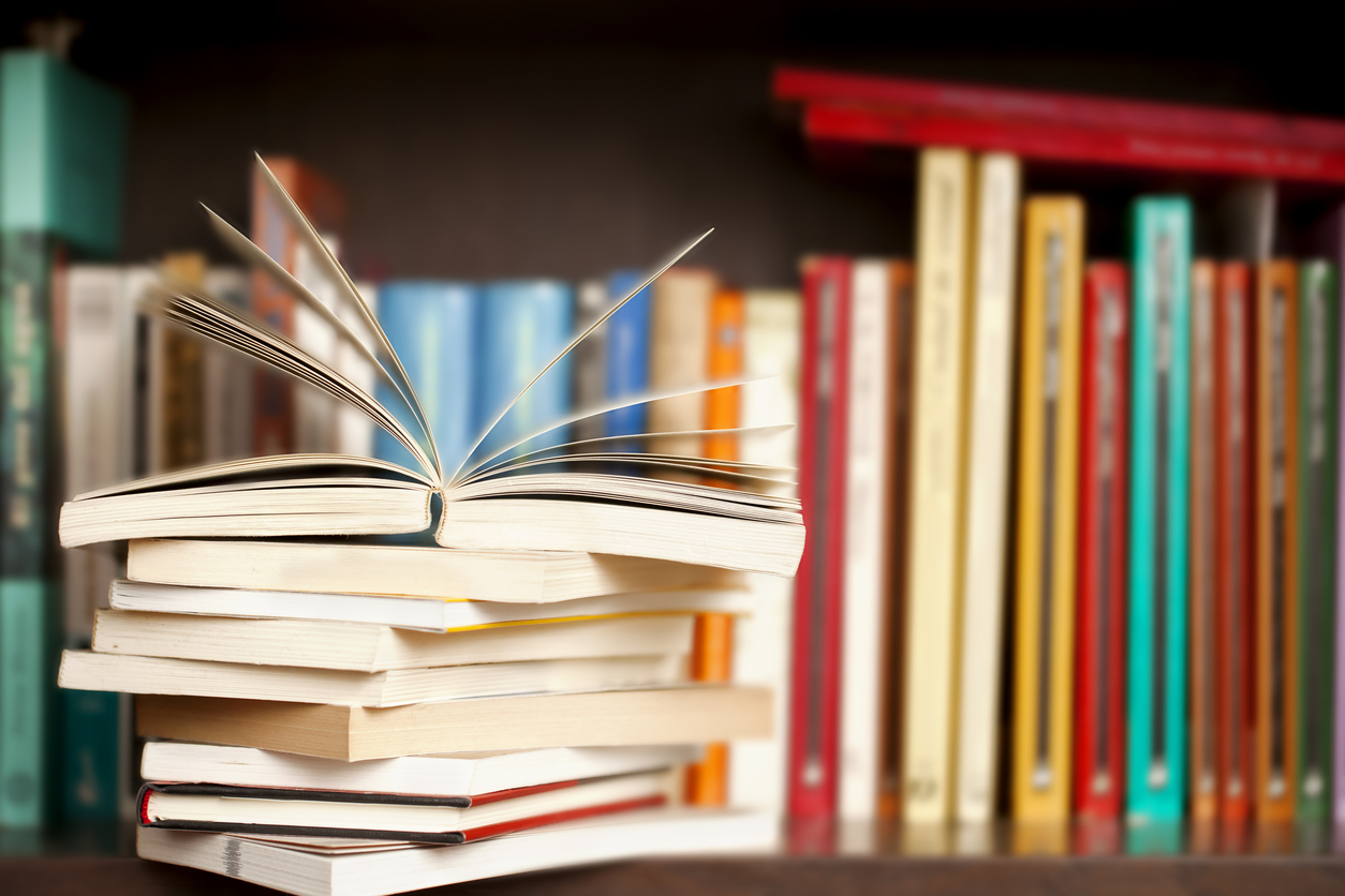 a stack of books on a book shelf