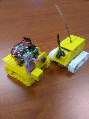 Two remote controlled rovers with caterpillar tracks. 