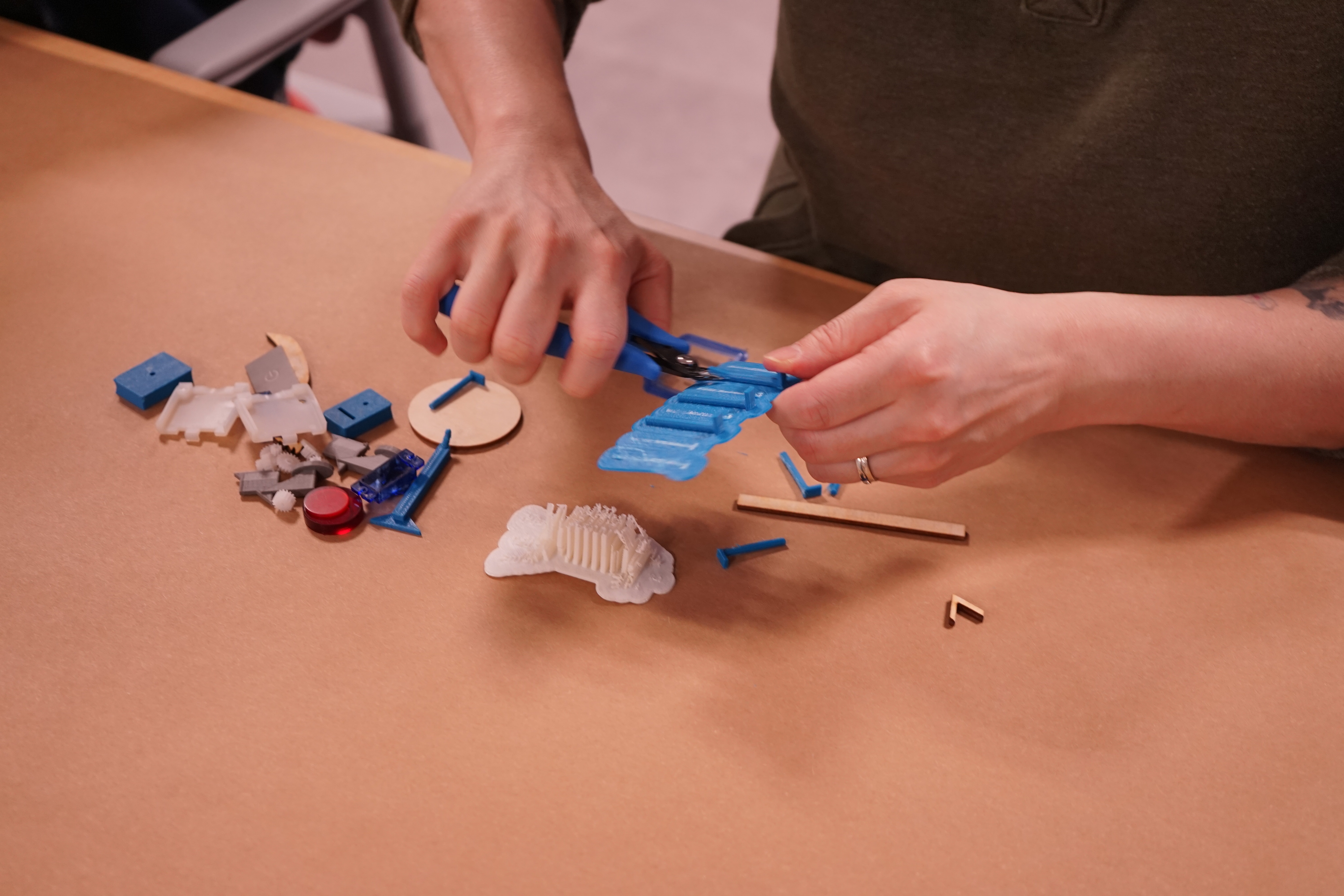 Hands making a model robot.