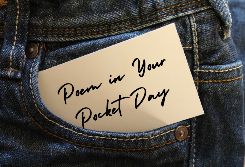 The front pocked of blue jeans with a note card sticking out that says "Poem in Your Pocket Day".