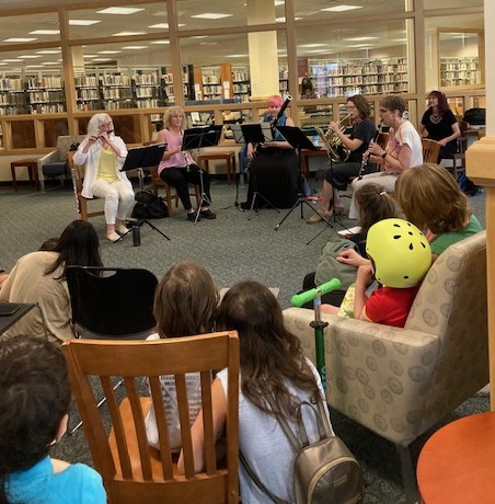 Photograph of Cayuga Chamber Orchestra and audience members in the Cornell Reading Room at TCPL.