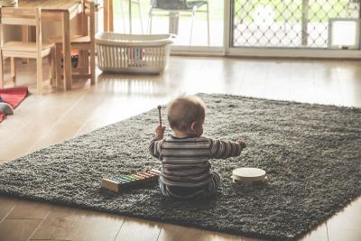 Baby playing with xylophone and tambourine