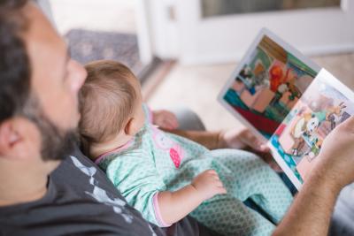Father reading a book to baby