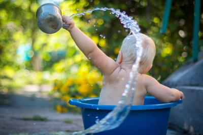 Baby splashing in a bucket
