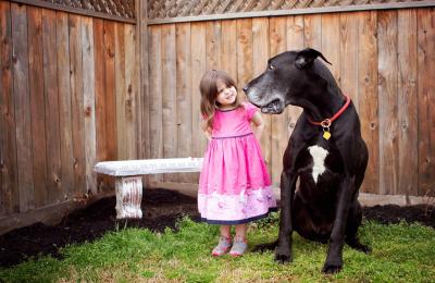 Young girl with large black dog
