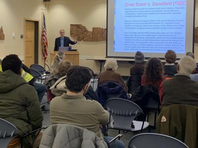 Professor Mike Dorf speaks to a crowd in the BorgWarner Community Room at Tompkins County Public Library