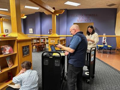 staff members placing RFID tags in childrens books