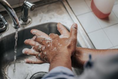 Image of person washing hands at sink