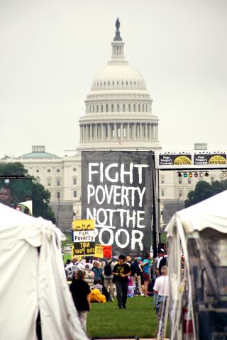 Image from Poor People's Campaign in 2018 of a sign in front of the capitol that reads "Fight Poverty Not the Poor"