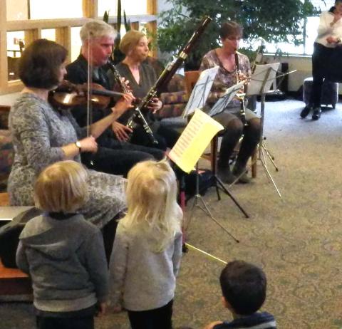two children watch chamber orchestra play