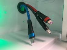 An image showing three adapters for a charging cable inside a locker. The connectors are Micro USB (colored blue), USB-C (colored black and silver), and Lightning (colored red)