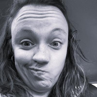 A black and white photo of Julia, a white woman with dark hair, making a weird face.
